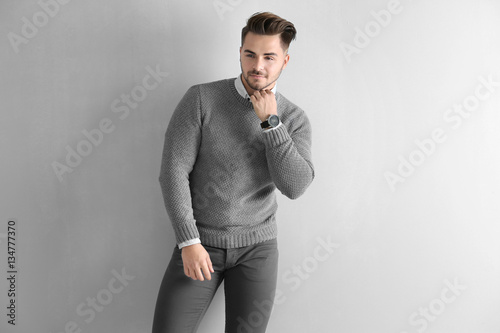 Handsome man on wall backgr...