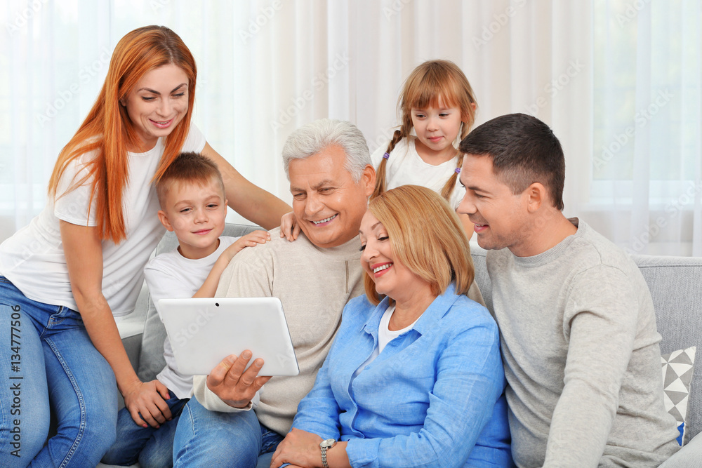 Happy family with tablet on couch Happy family with tablet on couch