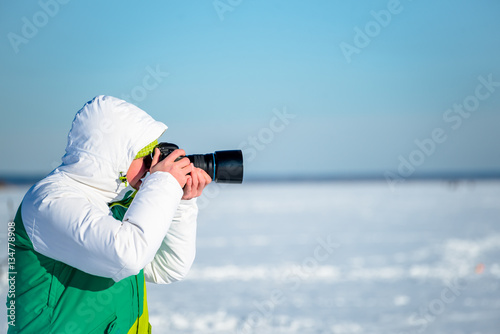 enthusiast photographer shoots report. In winter, on a frozen po