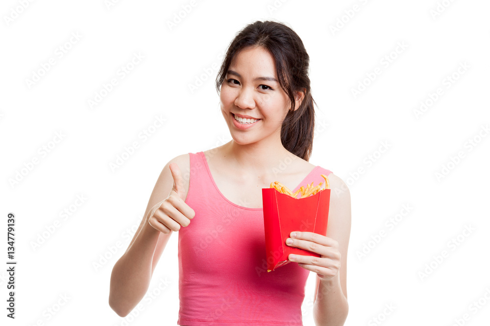Asian healthy girl eat french fries show thumbs up. Asian healthy girl eat french fries show thumbs up.