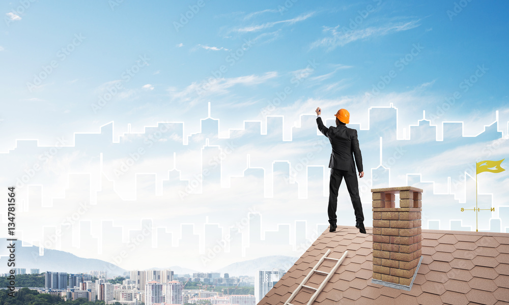 Man architect draw silhouette of modern city on blue sky. Mixed media Man architect draw silhouette of modern city on blue sky. Mixed media