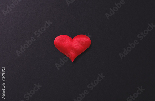 Red heart on black background.