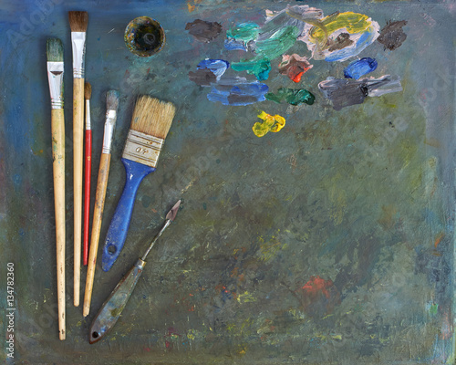 artists brushes and oil paints. Palette with paintbrush and palette-knife