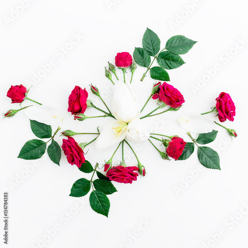 Valentines Day background. Floral pattern made red roses and tulip, green leaves, branches on white background. Flat lay, top view.
