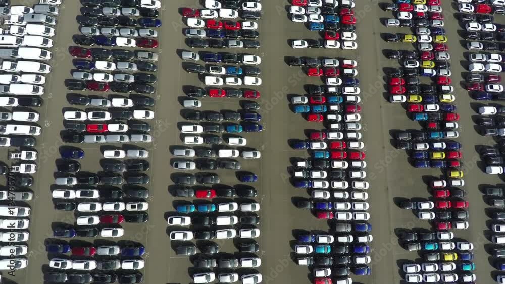 Aerial top down bird view new car storage parking lot showing imported new vehicles or ready to export new automobiles storage facility car industry for American and European market for car sales 4k Aerial top down bird view new car storage parking lot showing imported new vehicles or ready to export new automobiles storage facility car industry for American and European market for car sales 4k
