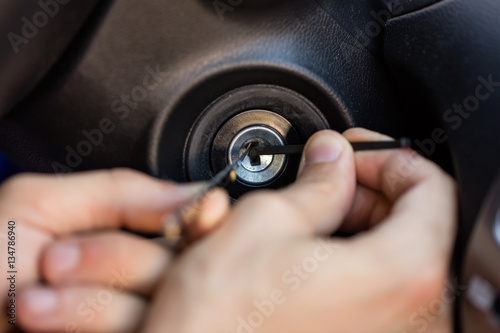 Person Inserting Tool In Key Hole
