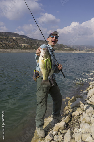 Fisherman with bass trophy