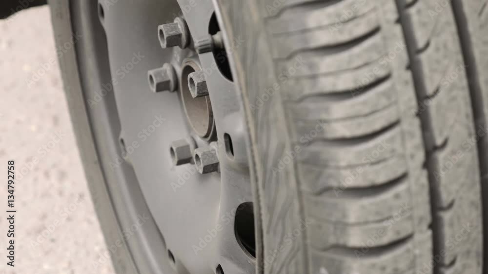 Close-up of car wheel parts - tire, rim. Vehicle components concept. Detailed shot. Camera moves from bottom to top. Close-up of car wheel parts - tire, rim. Vehicle components concept. Detailed shot. Camera moves from bottom to top.