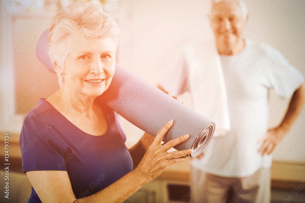 Senior couple packing up after workout Senior couple packing up after workout