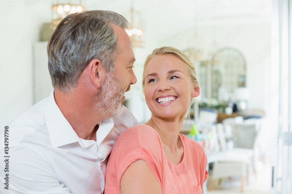 Couple embracing each other in kitchen Couple embracing each other in kitchen