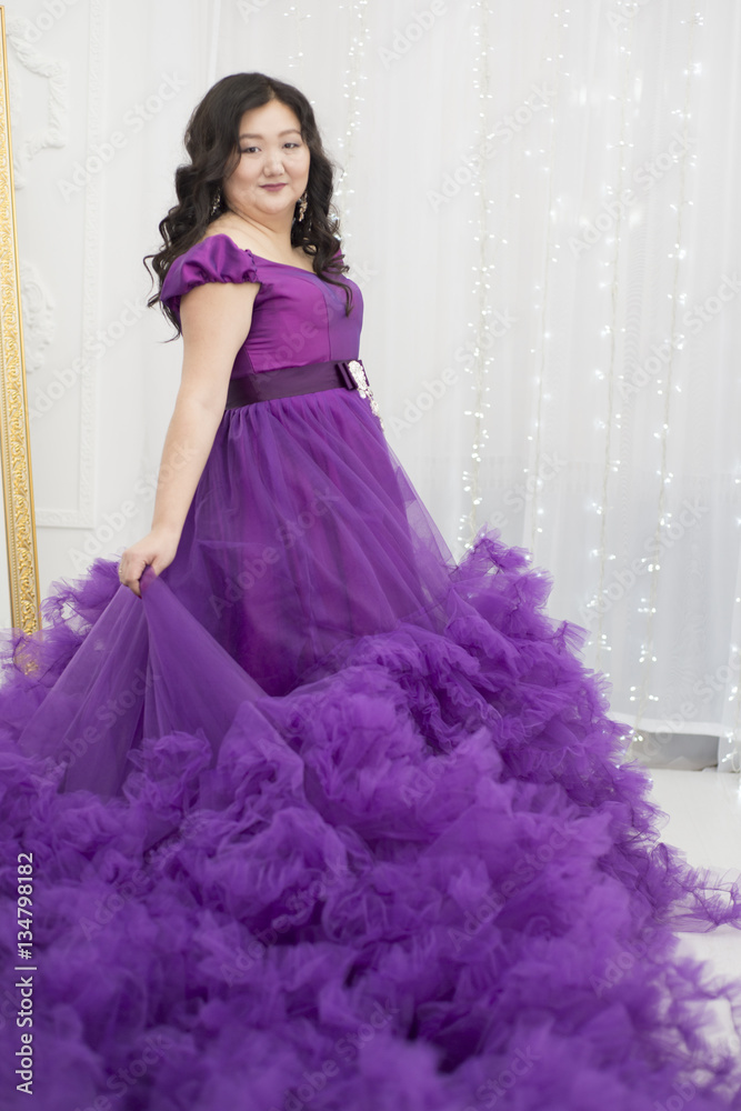 Full Asian woman in a lush lilac dress. Full Asian woman in a lush lilac dress.