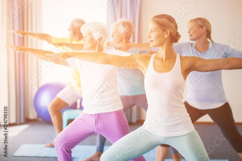 Instructor performing yoga with seniors