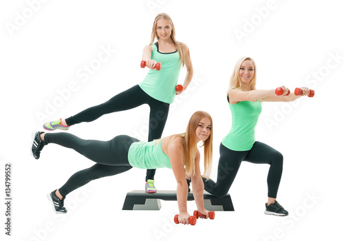 Slim sportswomen in tops and leggings pose in studio