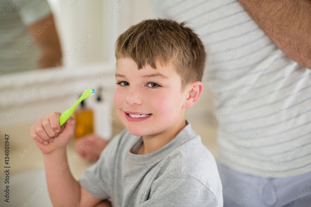Portrait of boy brushing teeth in bathroom Portrait of boy brushing teeth in bathroom