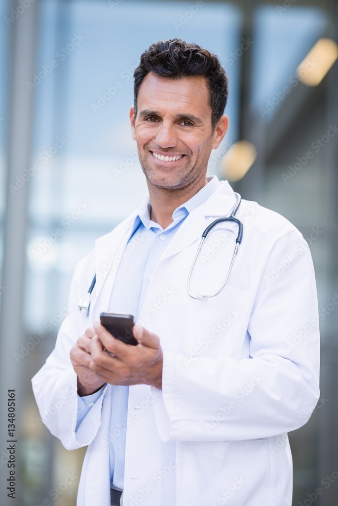 Portrait of smiling doctor using mobile phone Portrait of smiling doctor using mobile phone