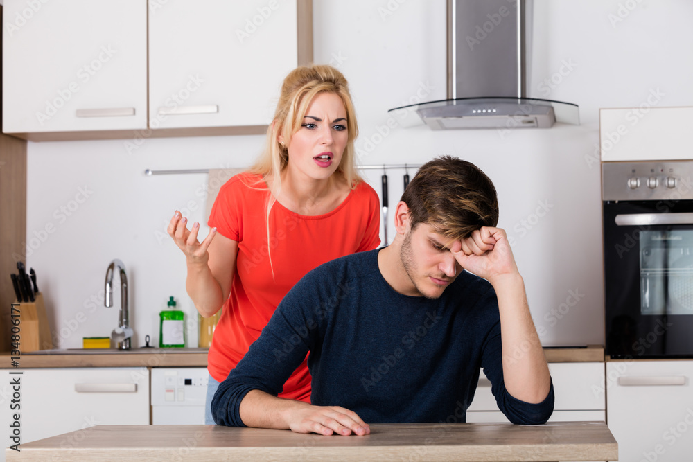 Woman Shouting To Her Husband In The Kitchen Woman Shouting To Her Husband In The Kitchen