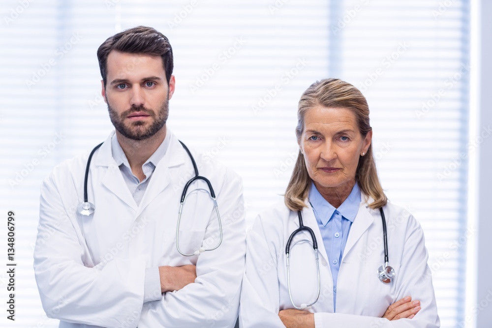 Portrait of doctors standing with arms crossed Portrait of doctors standing with arms crossed