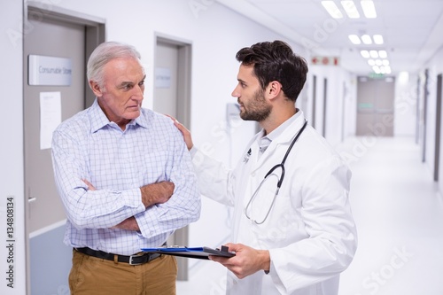 Doctor interacting with patient in corridor