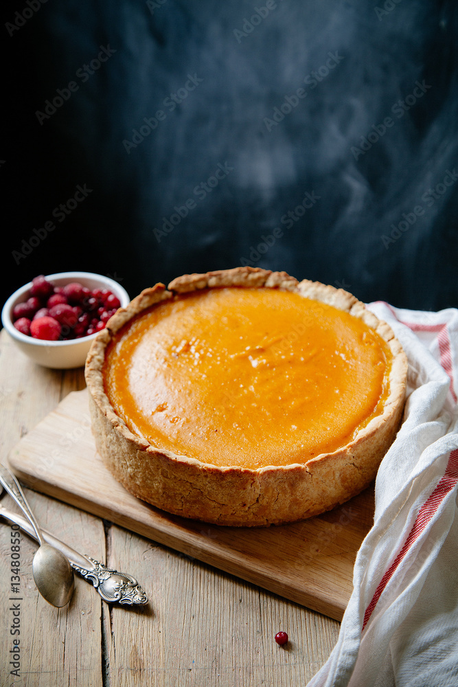 Pumpkin cheesecake with berries on wooden background. Rustic concept. Copy space Pumpkin cheesecake with berries on wooden background. Rustic concept. Copy space