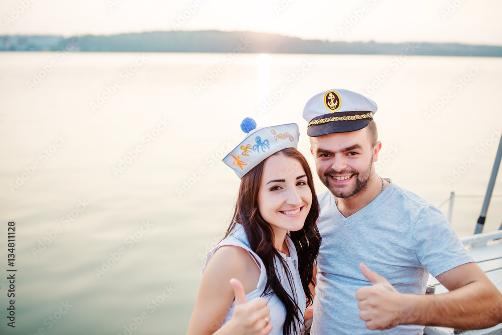 Young beautiful married couple in love at the yacht on vacation Young beautiful married couple in love at the yacht on vacation