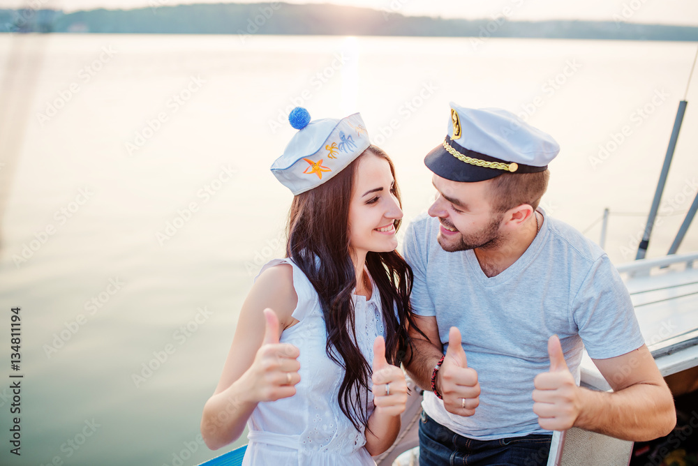 Young beautiful married couple in love at the yacht on vacation Young beautiful married couple in love at the yacht on vacation