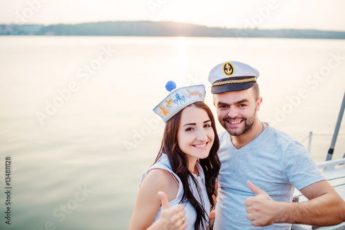 Young beautiful married couple in love at the yacht on vacation