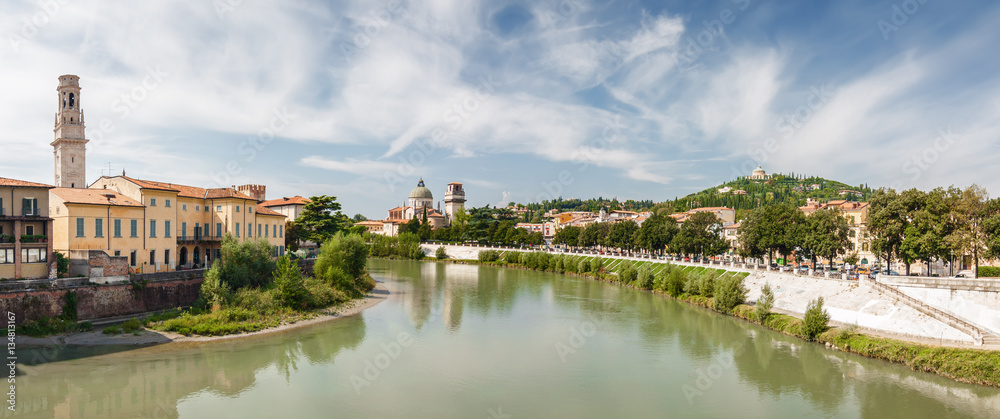 Sunny panoramic view of Adige river from Stone Bridge (Ponte di Pietra) in Verona, Veneto region, Italy.