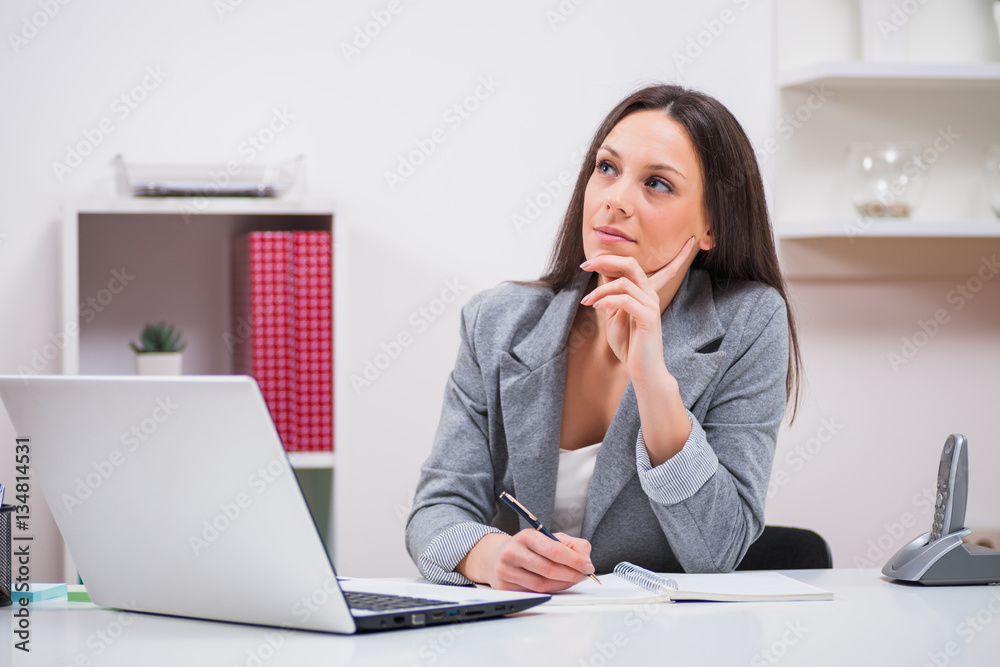 Young businesswoman is working in her office. Young businesswoman is working in her office.