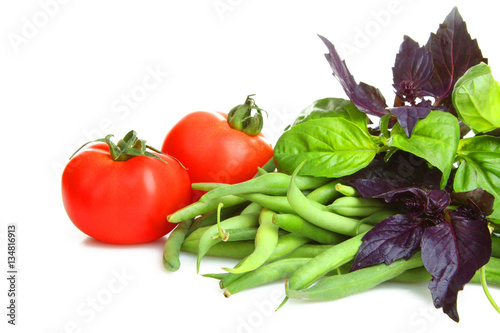 Fresh tomatoes, basil, green beans isolated on white background.The concept of a healthy lifestyle.