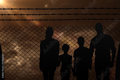 Composite image of portrait of happy family walking over white b