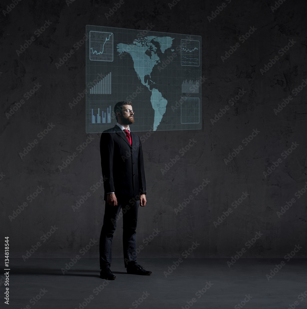 Businessman standing next to a futuristic map Businessman standing next to a futuristic map
