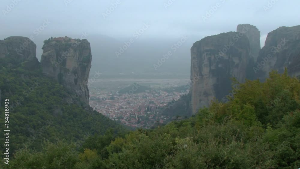 View from the monasteries of Meteora towards the town of Trikala. Shot on a misty day View from the monasteries of Meteora towards the town of Trikala. Shot on a misty day