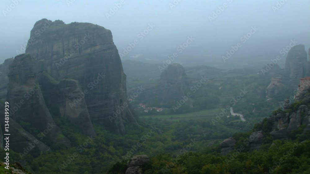 Pan across a misty view of the hills and monasteries of Meteora near Volos, Greece Pan across a misty view of the hills and monasteries of Meteora near Volos, Greece