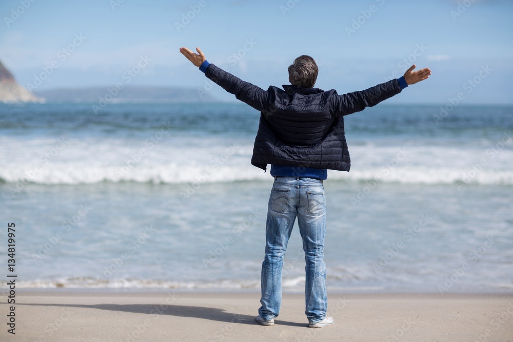 Mature man with arms outstretched standing on the beach Mature man with arms outstretched standing on the beach