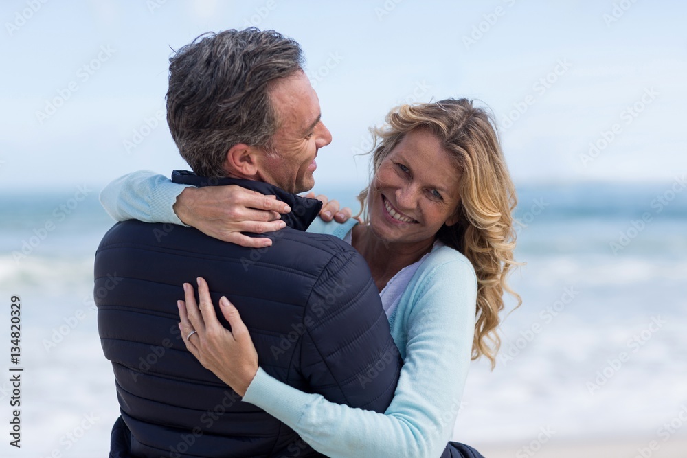 Mature couple embracing each other on the beach