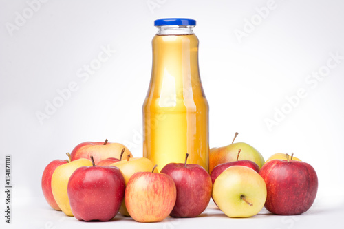 Apples with bottle of juice on white background