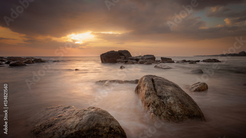 Beautiful sunset at the west coast of Sri Lanka. Great Atmosphere with long exposure and water motion blur. photo