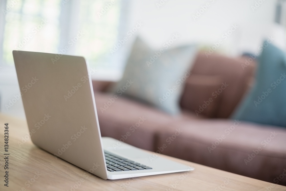 Close-up of laptop on table in living room Close-up of laptop on table in living room