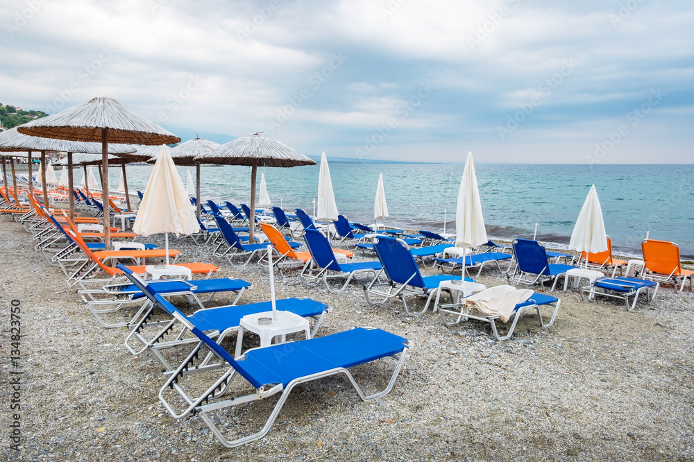 Empty beach chairs and umbrellas. Greece