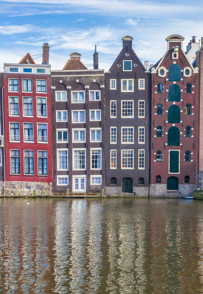 Colorful houses at the Damrak in Amsterdam