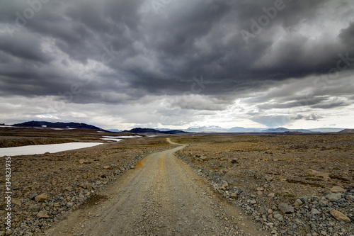 Traveling down a gravel road in Iceland. The dirt road F550 passes the Mars-like landscape of Kaldidalur. © Drepicter