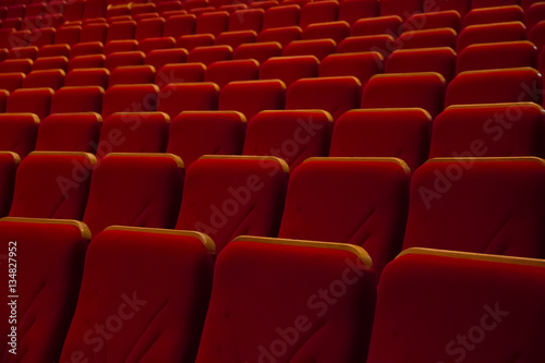 Rows of red chairs in movie theater
