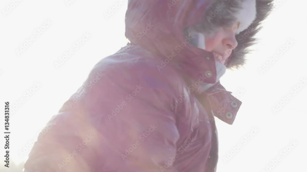 Happy child playing with snow in winter forest.
Happy child playing with snow in winter forest.
