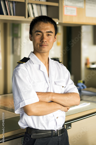 Young Chinese Navigator On Bridge