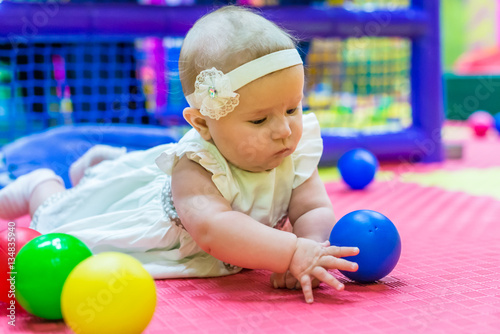 one of the babies playing in the nursery