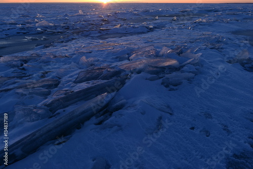 Winter ice desert of broken ice in the sunset light