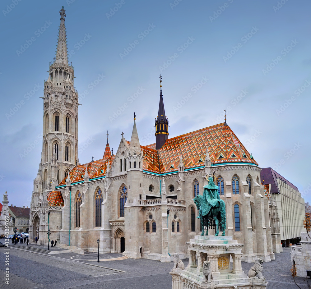 View on the Matthias Church and a sculpture of a man on a horse on a winter day. Shot from above. Budapest. View on the Matthias Church and a sculpture of a man on a horse on a winter day. Shot from above. Budapest.