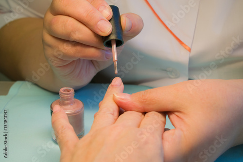 Treatment and painting of nails in a beauty salon