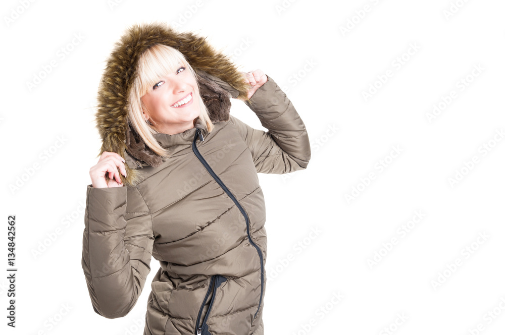Woman posing with winter jacket hood on and smiling Woman posing with winter jacket hood on and smiling