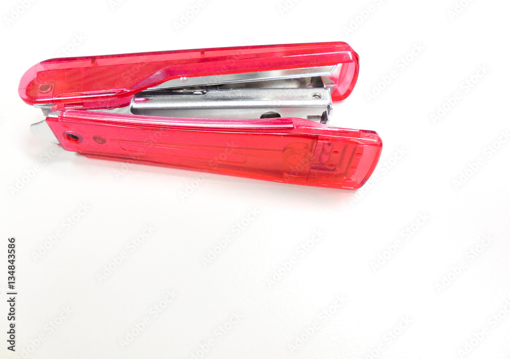 Soft focused picture of see through bright pink stapler on a white background Soft focused picture of see through bright pink stapler on a white background